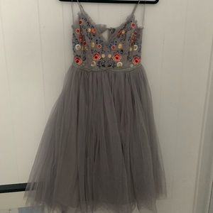 Gray Tulle dress with embroidered flower patterned top.